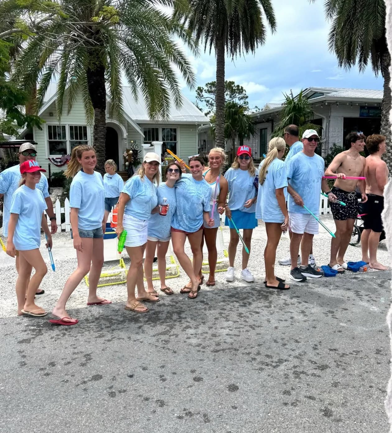 Friends in matching light blue shirts lined up under the palms on Pine Avenue on the Fourth of July
