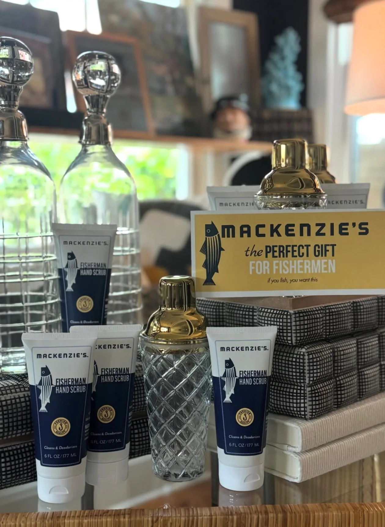 A gift display in the shop: cut-glass decanters, a crystal cocktail shaker and fisherman's hand scrub tubes