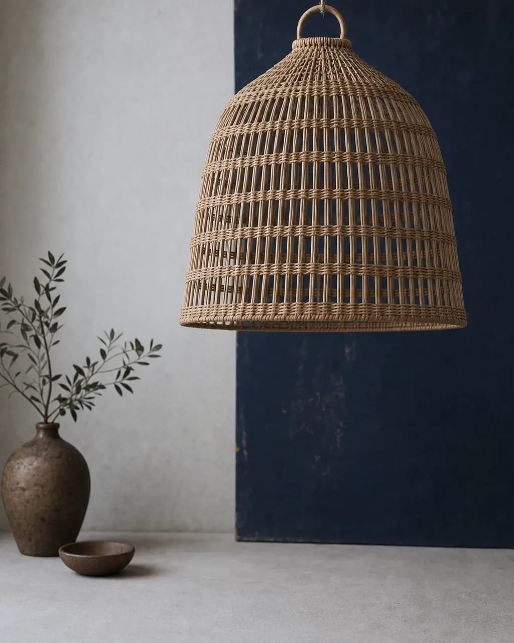 Woven Rattan Pendant Shade. An open rattan weave that throws warm, dappled light.